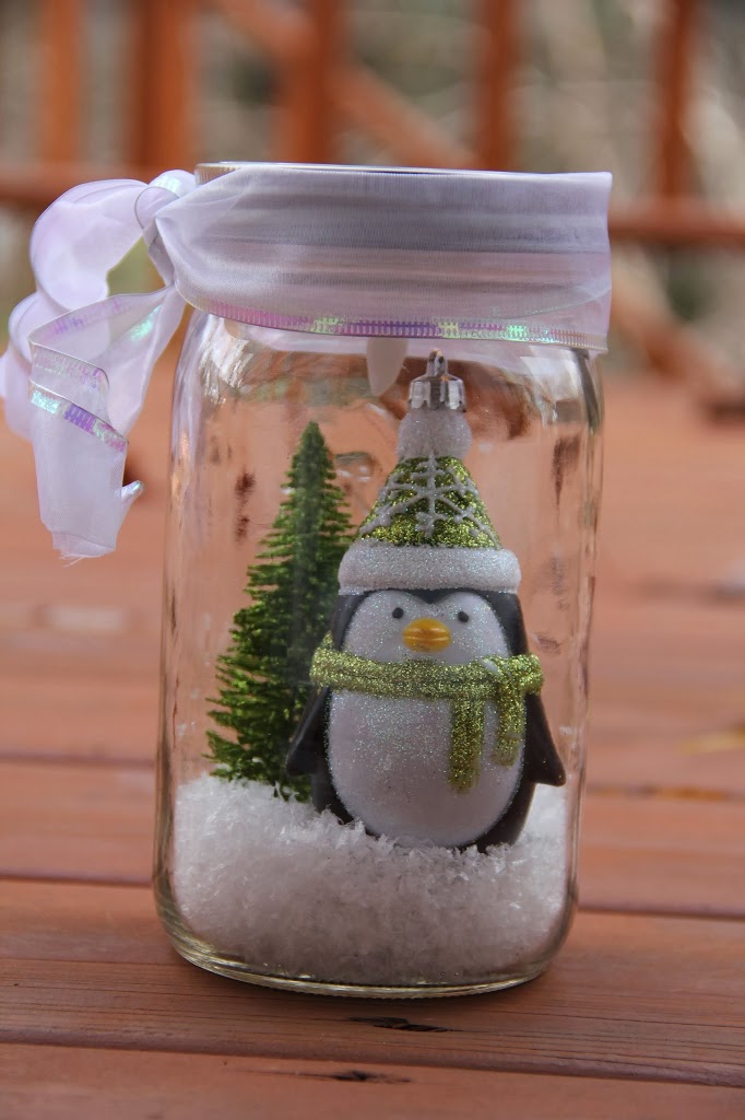 Illuminated Snow Scene in a Jar - An LED tea light illuminates a decorative winter scene inside of a mason jar. Such an easy and beautiful decoration for winter and Christmas!