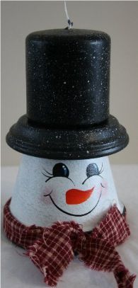 Handpainted snowman candle made from a terra cotta pot and saucer which is a hat and a black candle sits on top turning the saucer into his hat. Our snowman candle is accented with a country bow tied around his neck